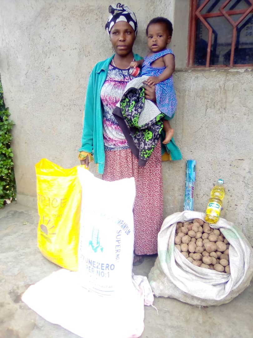 A woman and baby with food they have received
