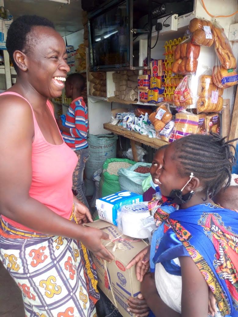 A woman and her children happily receive a food donation